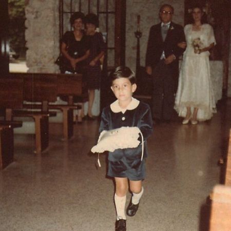 A childhood picture of Tom Llamas as a ring bearer at a wedding.